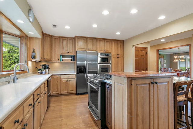 660 Plum Tree Dr, Barrington Hills, IL 60010 - kitchen with appliances with stainless steel finishes, a sink, a center island, a kitchen breakfast bar, and healthy amount of natural light