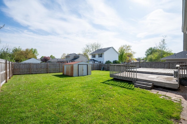 view of yard featuring a storage unit, a deck, and an outdoor structure
