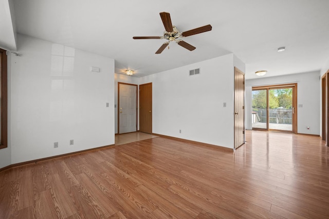 unfurnished living room featuring a ceiling fan, light wood-style flooring, and baseboards