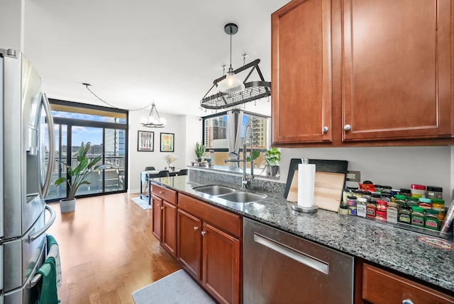 1160 S Michigan Ave Unit 1005, Chicago, IL 60605 - kitchen with stainless steel appliances, light wood-type flooring, a sink, dark stone countertops, and a chandelier