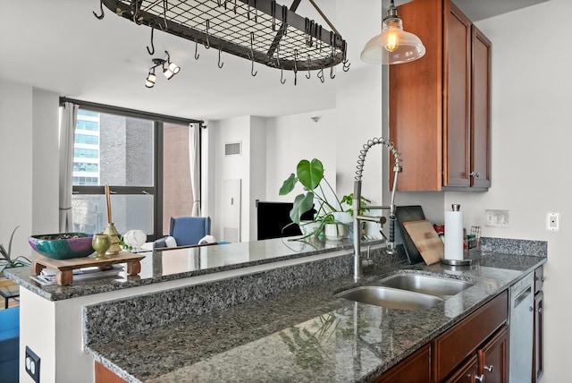 1160 S Michigan Ave Unit 1005, Chicago, IL 60605 - kitchen with a sink, dark stone countertops, a peninsula, and brown cabinets