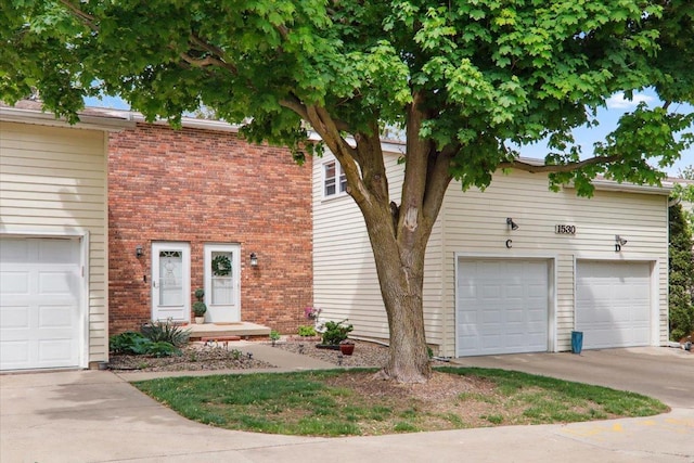 view of front of home with brick siding and a garage