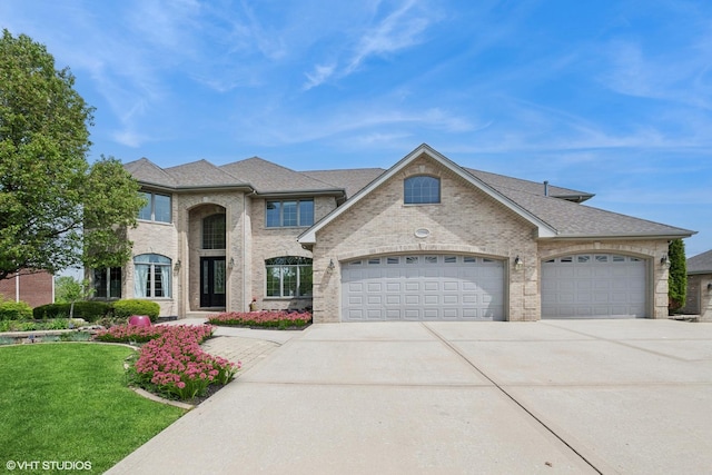 22844 Lakeview Estates Blvd, Frankfort, IL 60423 - french provincial home with a garage, concrete driveway, a front yard, and brick siding