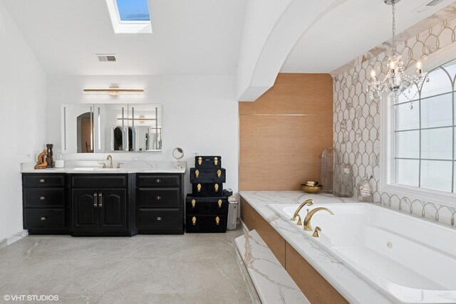 22844 Lakeview Estates Blvd, Frankfort, IL 60423 - bathroom featuring a chandelier, a whirlpool tub, vanity, and a skylight