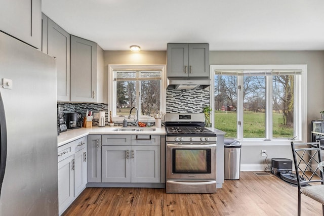 31 Bruce Ct N, Lockport, IL 60441 - kitchen featuring appliances with stainless steel finishes, gray cabinetry, a sink, and under cabinet range hood