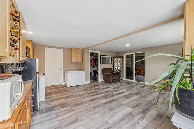 31 Bruce Ct N, Lockport, IL 60441 - kitchen with refrigerator, white microwave, open floor plan, light countertops, and light wood finished floors