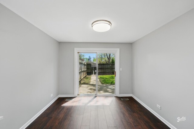 unfurnished room with wood finished floors and baseboards