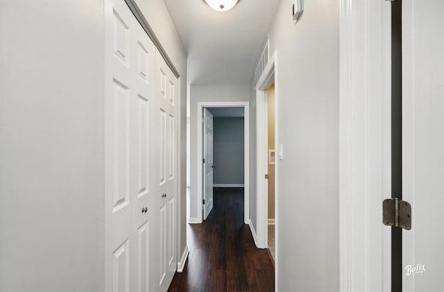 hall featuring dark wood finished floors and baseboards