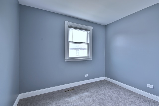 spare room with carpet floors and baseboards