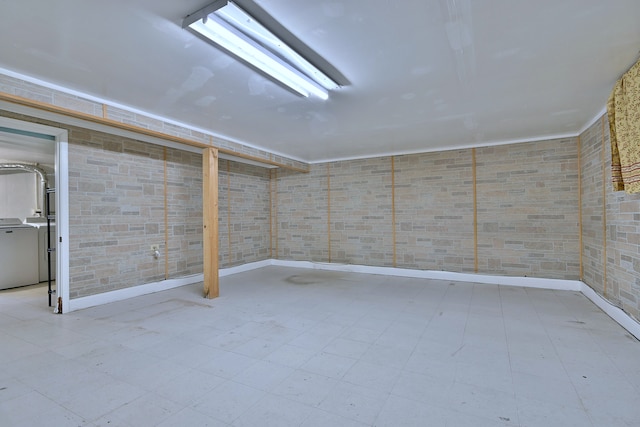 below grade area featuring washer / dryer and baseboards