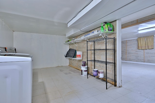 washroom with tile patterned floors and brick wall