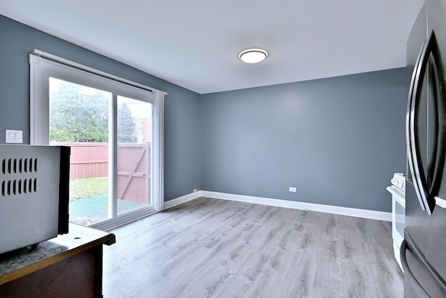 empty room featuring wood finished floors and baseboards