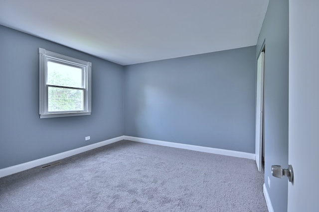 carpeted spare room with baseboards