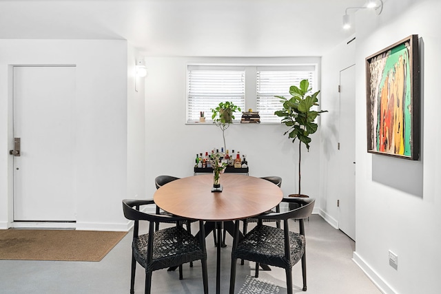 dining area with concrete floors and baseboards