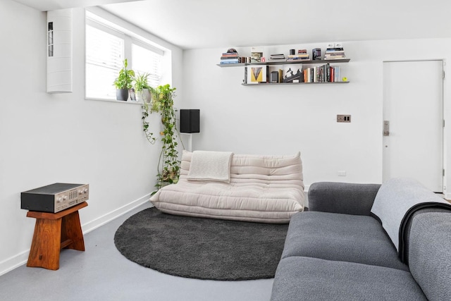 living area featuring baseboards