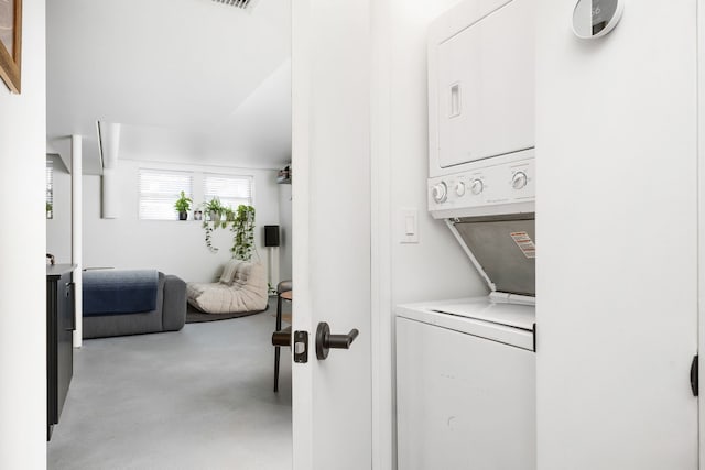 laundry area with stacked washer and clothes dryer