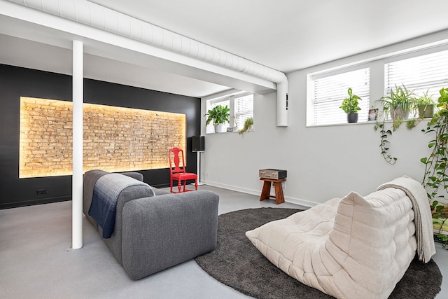 living area featuring carpet and baseboards