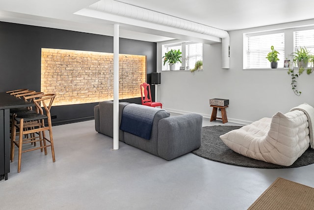 living room with plenty of natural light and concrete floors