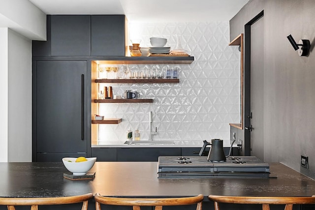 indoor dry bar featuring paneled refrigerator