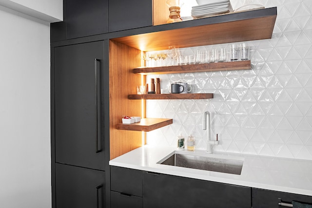 indoor dry bar featuring paneled built in fridge