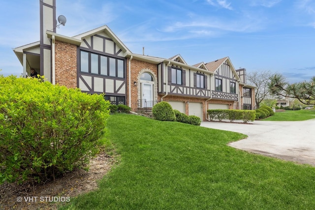 17581 Windsor Pkwy Unit 1, Tinley Park, IL 60477 - back of property with an attached garage, driveway, brick siding, and a yard