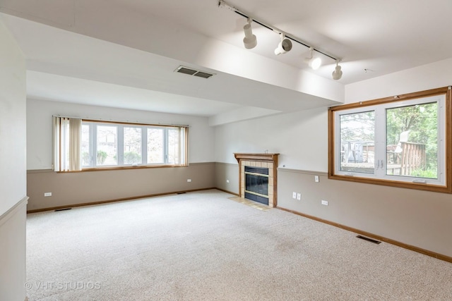 17581 Windsor Pkwy Unit 1, Tinley Park, IL 60477 - unfurnished living room featuring rail lighting, carpet flooring, a tile fireplace, and baseboards