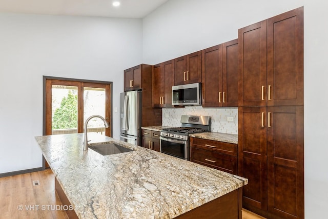 17581 Windsor Pkwy Unit 1, Tinley Park, IL 60477 - kitchen with appliances with stainless steel finishes, a sink, an island with sink, a towering ceiling, and tasteful backsplash
