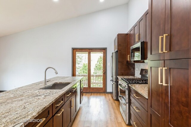 17581 Windsor Pkwy Unit 1, Tinley Park, IL 60477 - kitchen with stainless steel appliances, a sink, light wood-type flooring, light stone counters, and recessed lighting