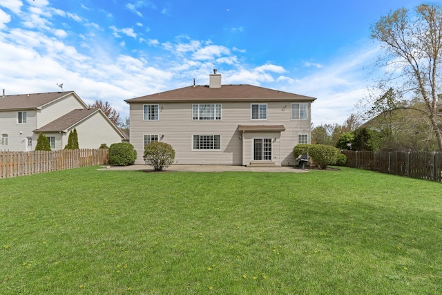 back of property with a patio and a chimney