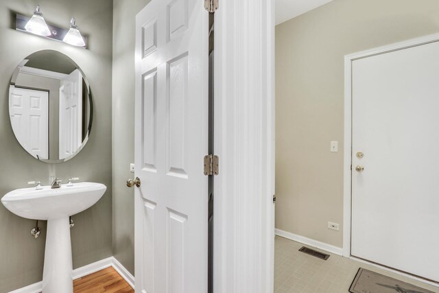 bathroom with baseboards and tile patterned floors
