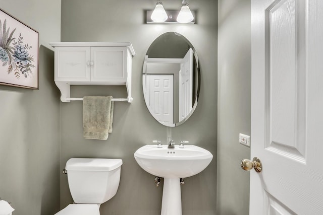half bathroom featuring toilet
