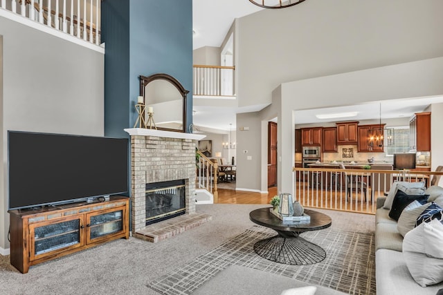 living room featuring a high ceiling, a fireplace, and baseboards