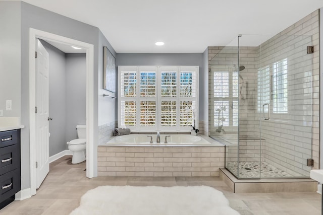 full bath with toilet, a garden tub, a stall shower, and vanity