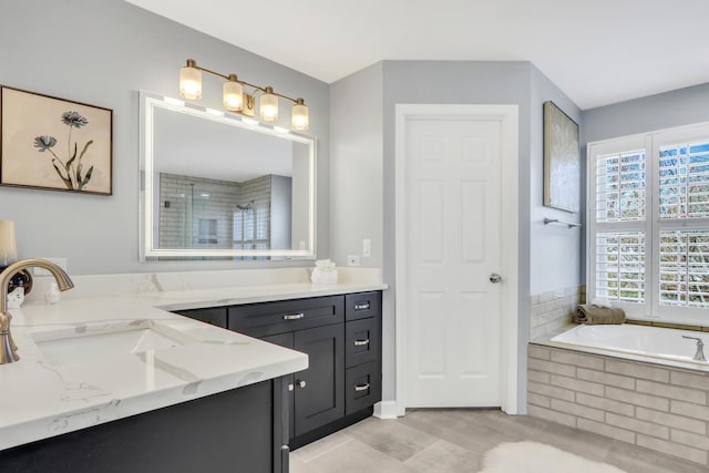 bathroom featuring a shower stall, vanity, a bath, and wood finished floors