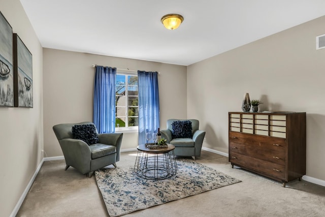 sitting room featuring carpet and baseboards