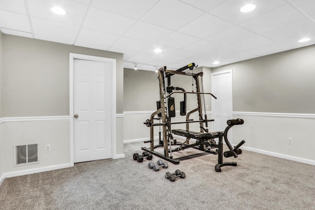 workout area featuring carpet flooring, baseboards, a paneled ceiling, and recessed lighting
