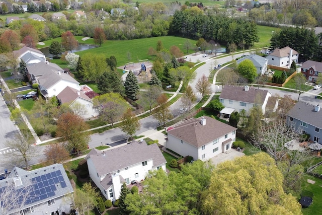 view of property location with nearby suburban area, a tree filled landscape, and a large body of water