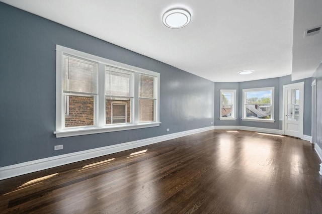 1235 N Mason Ave, Chicago, IL 60651 - unfurnished living room featuring wood finished floors and baseboards