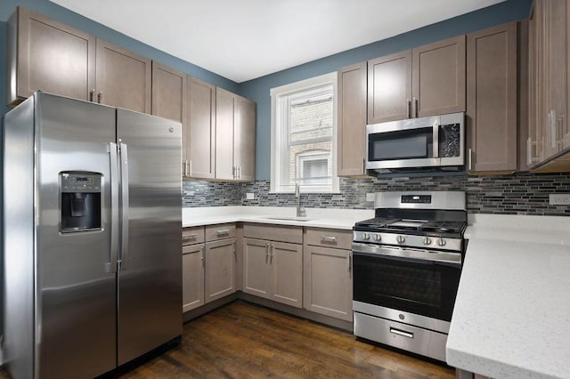 1235 N Mason Ave, Chicago, IL 60651 - kitchen with appliances with stainless steel finishes, a sink, backsplash, and dark wood-style flooring