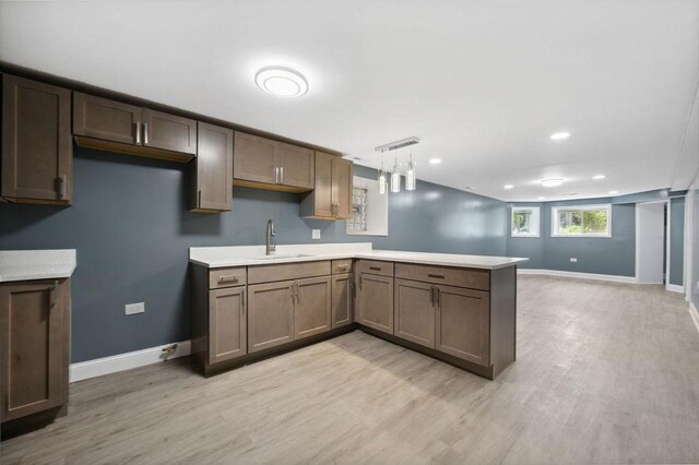 1235 N Mason Ave, Chicago, IL 60651 - kitchen with a peninsula, a sink, baseboards, light wood-type flooring, and recessed lighting
