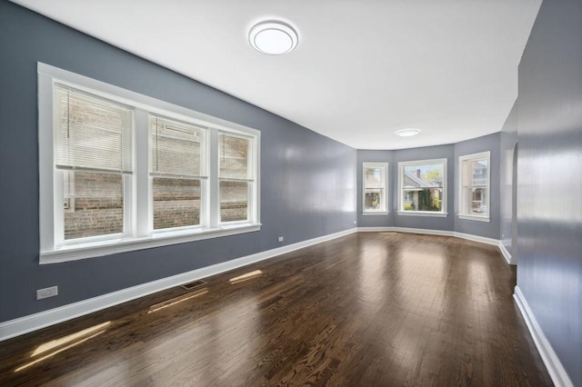 1235 N Mason Ave, Chicago, IL 60651 - unfurnished living room featuring wood finished floors and baseboards