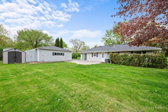 3700 Theodore St, Joliet, IL 60431 - rear view of house featuring a shed, a patio area, an outdoor structure, cooling unit, and a yard