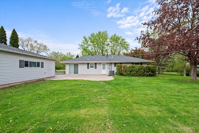 3700 Theodore St, Joliet, IL 60431 - back of property with a patio area, central AC unit, and a lawn