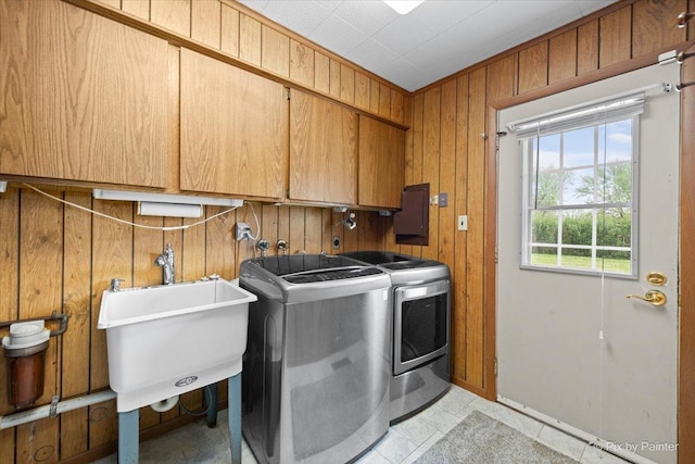 3700 Theodore St, Joliet, IL 60431 - laundry area with washer and clothes dryer, cabinet space, wooden walls, and electric panel