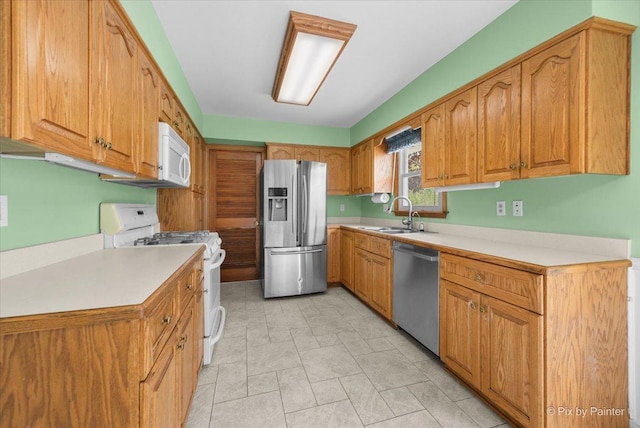 3700 Theodore St, Joliet, IL 60431 - kitchen featuring stainless steel appliances, a sink, light countertops, and brown cabinets