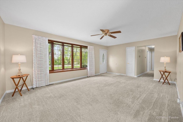 3700 Theodore St, Joliet, IL 60431 - unfurnished living room featuring carpet, a ceiling fan, and baseboards