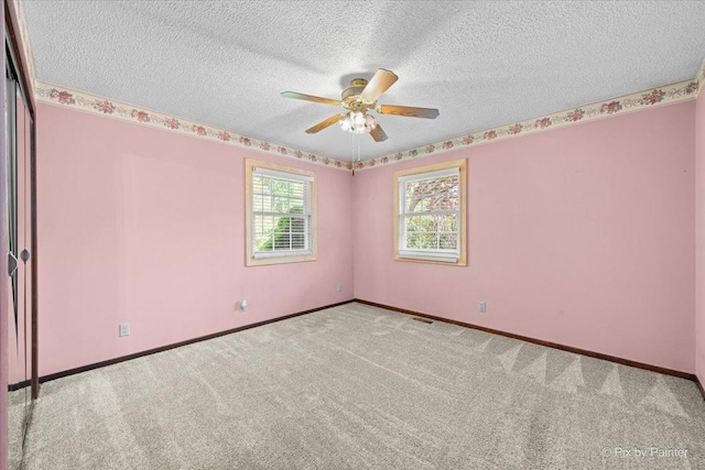3700 Theodore St, Joliet, IL 60431 - spare room with carpet, ceiling fan, baseboards, and a textured ceiling