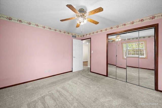 3700 Theodore St, Joliet, IL 60431 - unfurnished bedroom featuring carpet, a textured ceiling, baseboards, a closet, and a ceiling fan