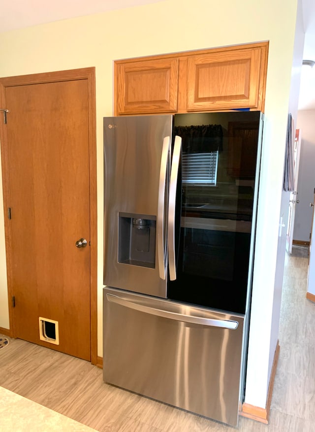 1453 Bluestem Ln, Minooka, IL 60447 - kitchen with stainless steel fridge with ice dispenser, light wood-style flooring, and brown cabinets