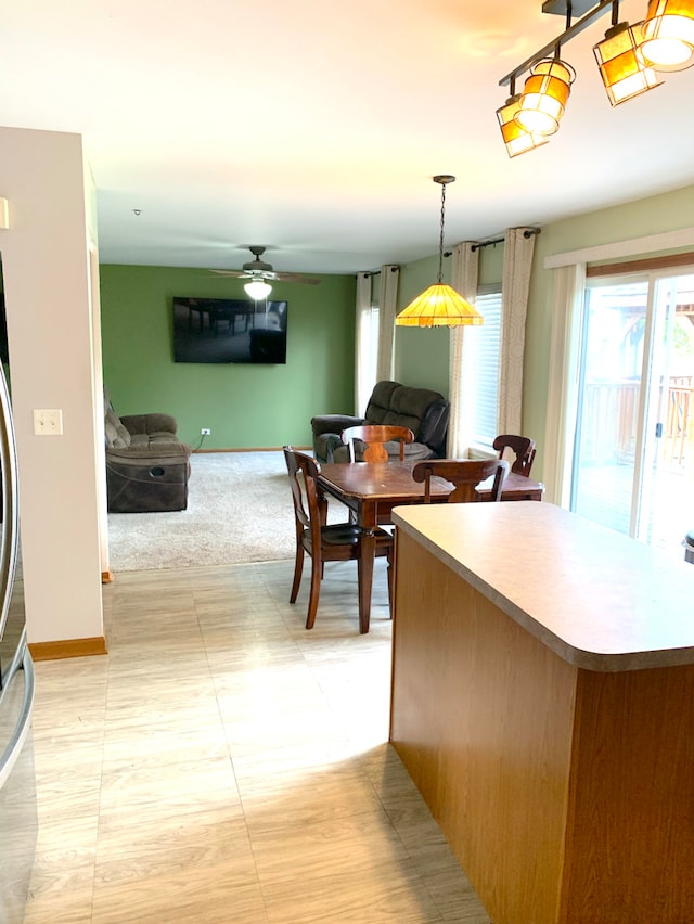 1453 Bluestem Ln, Minooka, IL 60447 - kitchen with open floor plan, a ceiling fan, and baseboards